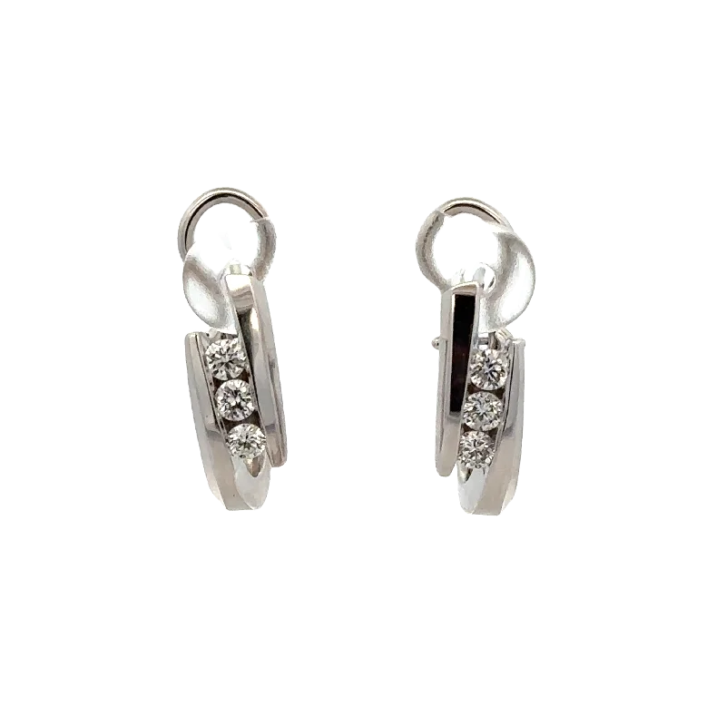 Oval - cut sapphire and diamond engagement ring in 18K white goldDiamond Huggie Earrings in White Gold Oval - cut sapphire and diamond engagement ring in 18K white goldDiamond Huggie Earrings in White Gold