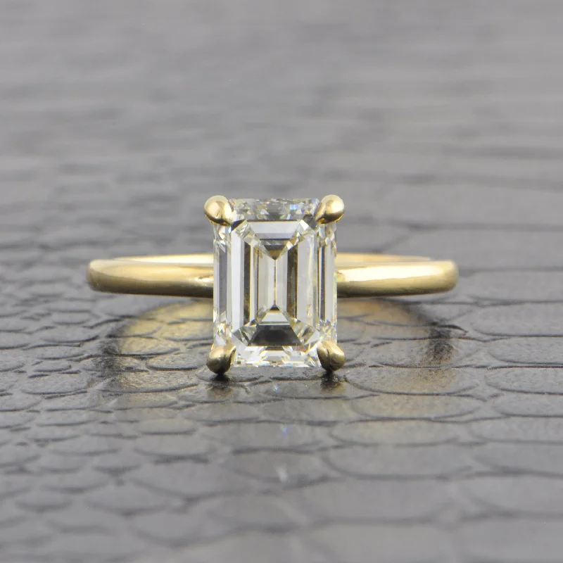 Vintage - style engagement ring with filigree details and sapphire accents in 14K yellow goldGIA 2.01 ct. I-VVS2 Emerald Cut Diamond Engagement Ring in Yellow Gold Vintage - style engagement ring with filigree details and sapphire accents in 14K yellow goldGIA 2.01 ct. I-VVS2 Emerald Cut Diamond Engagement Ring in Yellow Gold