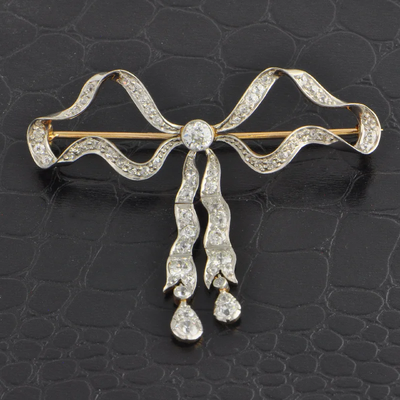 Cushion - cut diamond engagement ring with a halo of moissanite in a silver - plated bandAntique Edwardian Diamond Bow Brooch in 18k Yellow Gold and Platinum Cushion - cut diamond engagement ring with a halo of moissanite in a silver - plated bandAntique Edwardian Diamond Bow Brooch in 18k Yellow Gold and Platinum