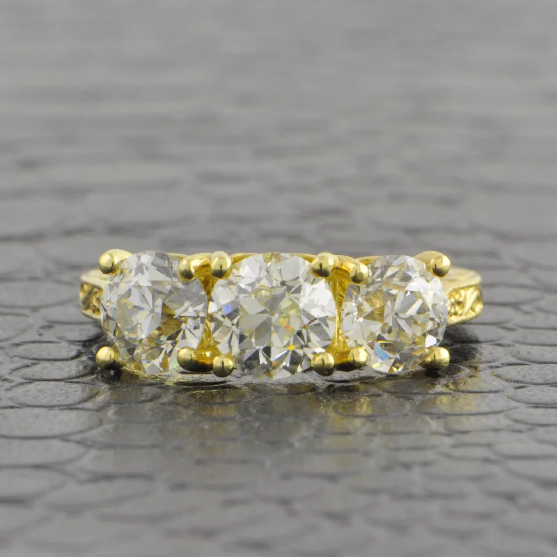 Halo diamond engagement ring in 18K white gold with a center oval - cut stoneVintage Inspired Three Stone Old European Cut Diamond Ring in 18k Yellow Gold Halo diamond engagement ring in 18K white gold with a center oval - cut stoneVintage Inspired Three Stone Old European Cut Diamond Ring in 18k Yellow Gold