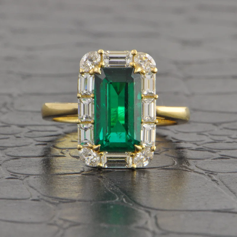 Emerald - cut diamond engagement ring set in a modern titanium bandElongated Emerald and Diamond Halo Ring in Yellow Gold Emerald - cut diamond engagement ring set in a modern titanium bandElongated Emerald and Diamond Halo Ring in Yellow Gold