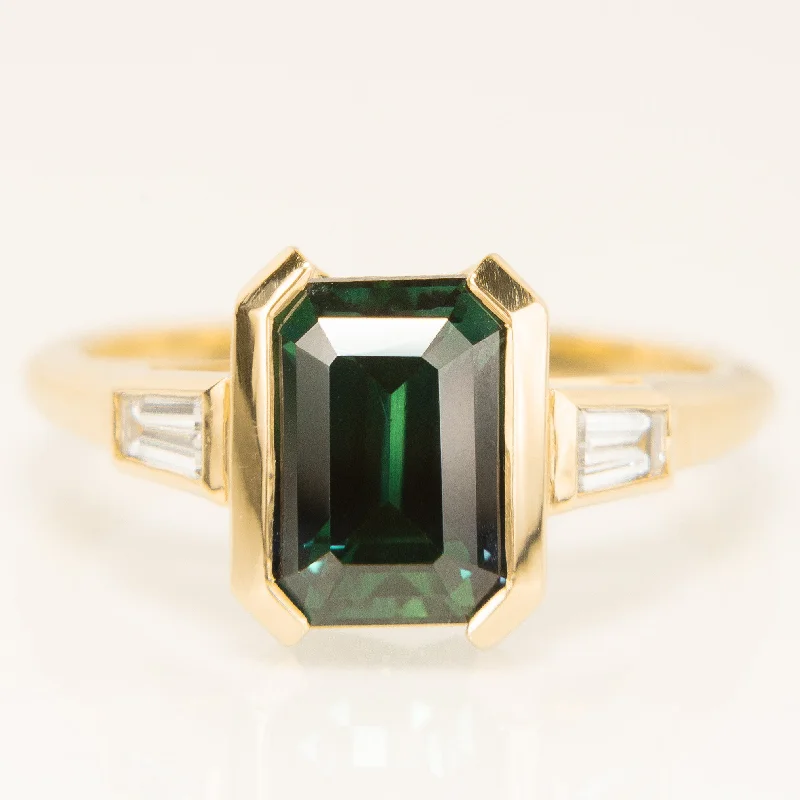 Engagement Rings with Amethyst and Diamond Accents in a Contemporary SettingEmerald Cut Teal Sapphire Trilogy Ring in 18k Yellow Gold Engagement Rings with Amethyst and Diamond Accents in a Contemporary SettingEmerald Cut Teal Sapphire Trilogy Ring in 18k Yellow Gold